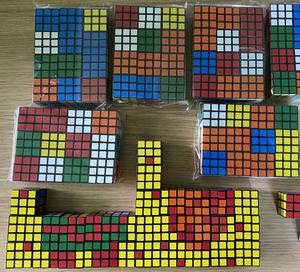 A collection of many Rubik's Cubes on a table
